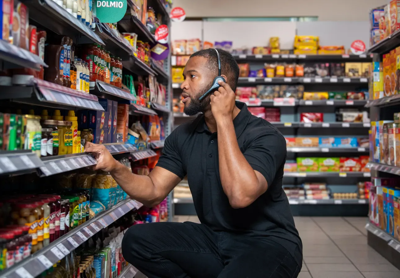 Associate wearing a Pro12 headset restocking a low shelf