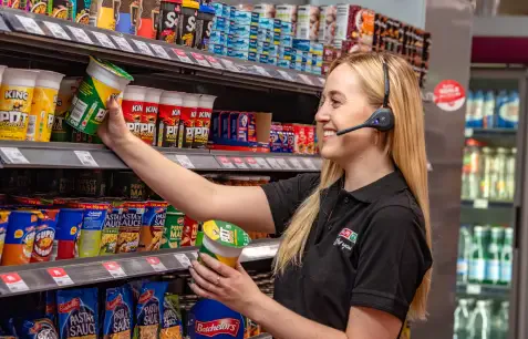 Associate with a Pro12 headset picking from a snack aisle